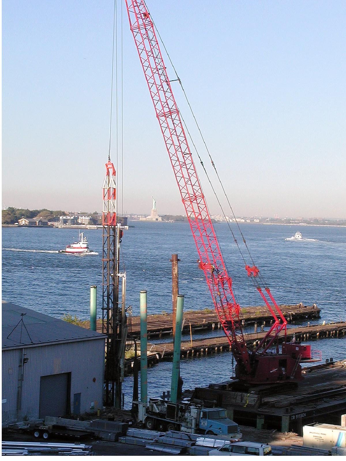 Historic Reicon crane operation with Statue of Liberty in the background
